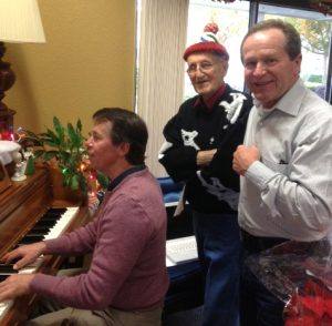Music teacher Andy Darrow with a resident and Chip Rawson