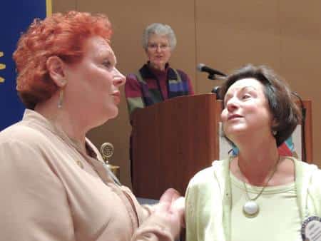 Debi Zaft sings Happy birthday while Ginny Cannon listens