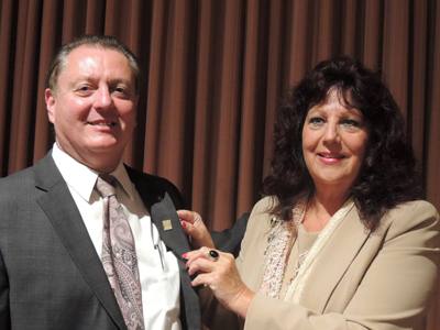 Donna Lee gives Doug Johnson a Rotoplast pin
