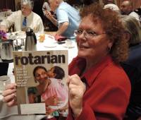 Debi Zaft showing the cover of this month's Rotarian magazine