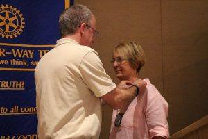 Matt Fannin passes off the Rotarian of the Year to Diane Moresi