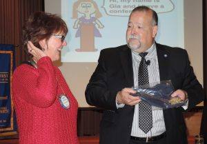 Rotarian of the Month - Kathy Schwartz. President Jose presenting a Rotary t-shirt and gift certificate