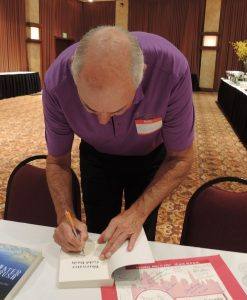 Guest speaker autographing books for the Rotarians