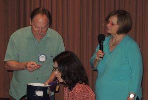 Doug Roberts calls the lucky raffle number as Cathy Vicini looks on.