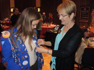 Doug Johnson generously gives her his Peace Pin for her vest! Diane Moresi pins it on!!